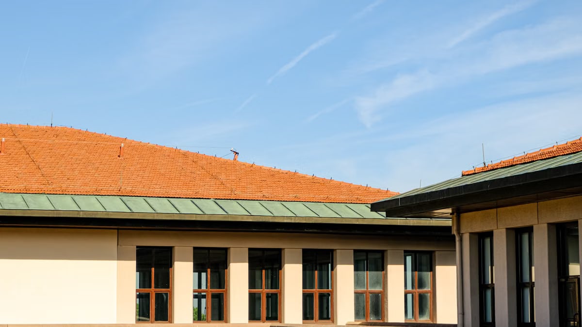 Contemporary architecture featuring clean rooflines against a bright blue sky.